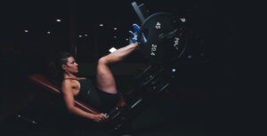 a woman performing the leg press at the gym