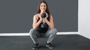 a woman performing a dumbbell goblet squat